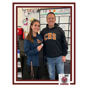 A woman and man in CHS sweatshirts smiling