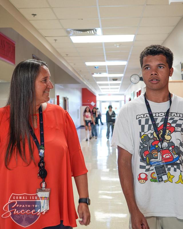 Ms. Duncan and a MECHS student walking through the hall during lunch time.