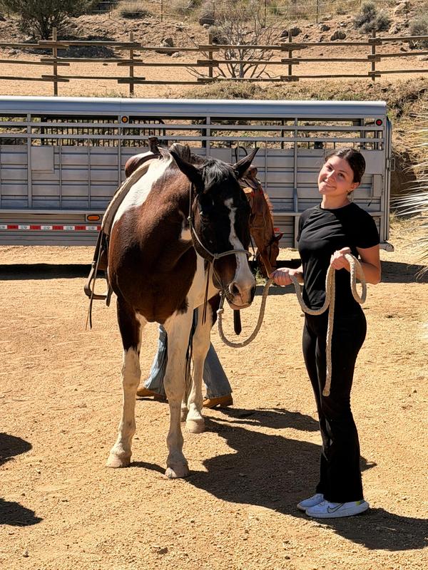 Student posing with a horse