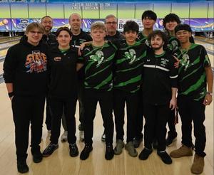 group of young men and pose in front of a bowling lane