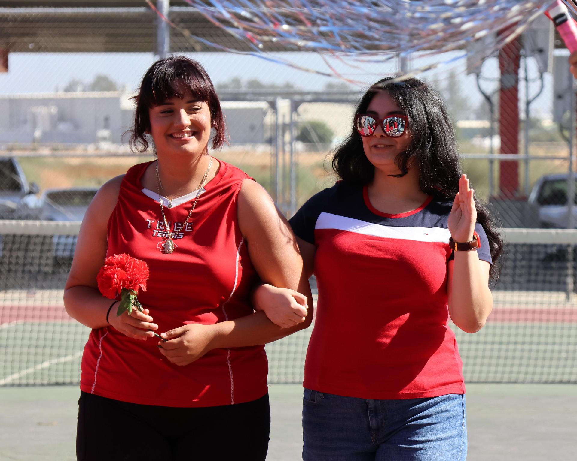 tennis players, family, and staff celebrating senior night
