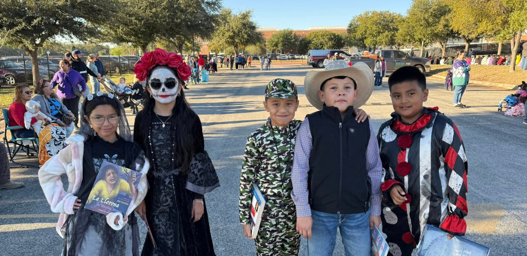 2 girls and 3 boys wearing Halloween costumes (Dia de los Muertos, military, cowboy, clown)