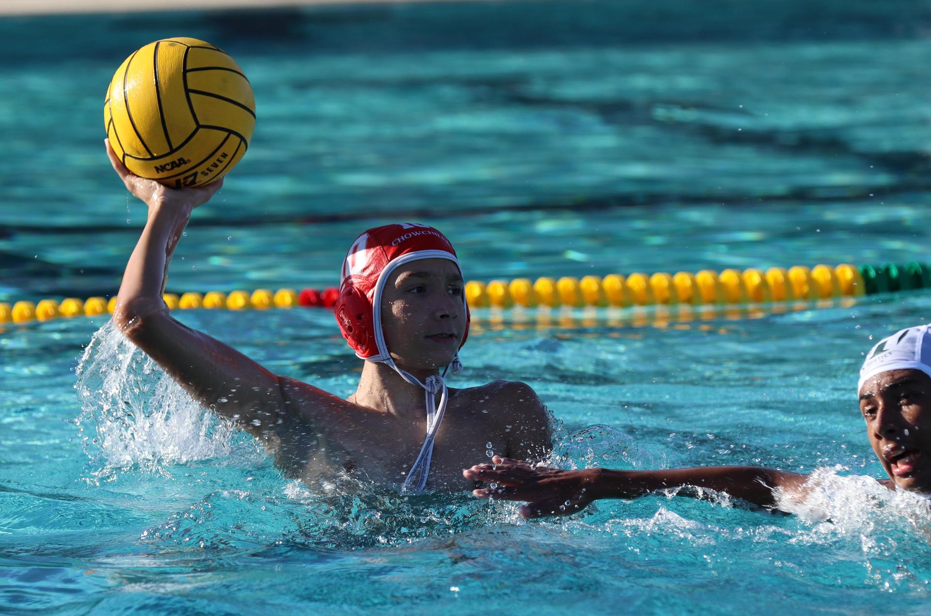 boys water polo players in action against hoover
