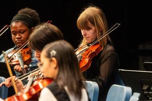 The 8th grade orchestra performs