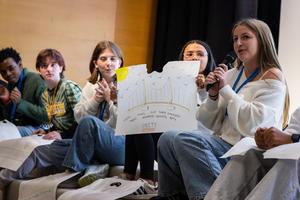 A student shows off a drawing