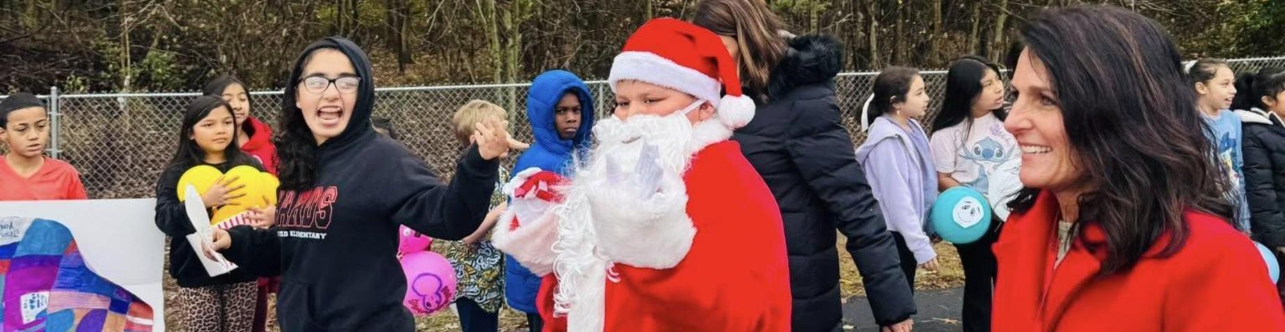 Picture of a student dressed like Santa in the parade.