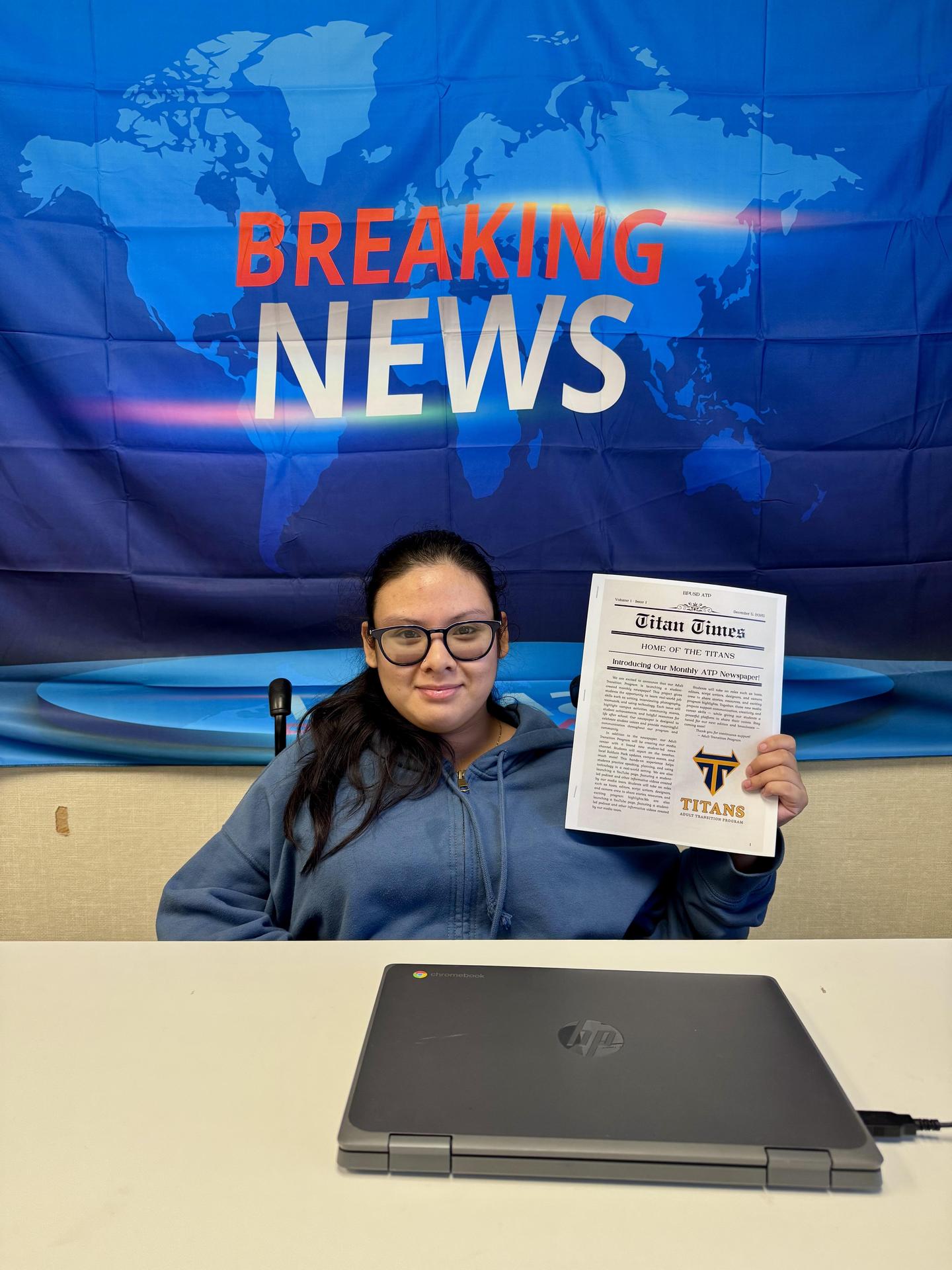 Student poses with newsletter at ATP, 2025