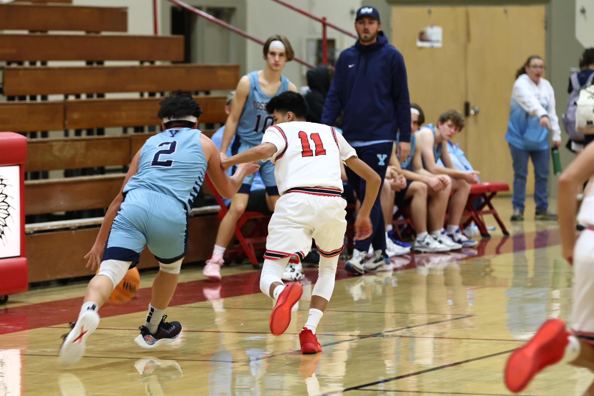 Varsity boys playing basketball against yosemite