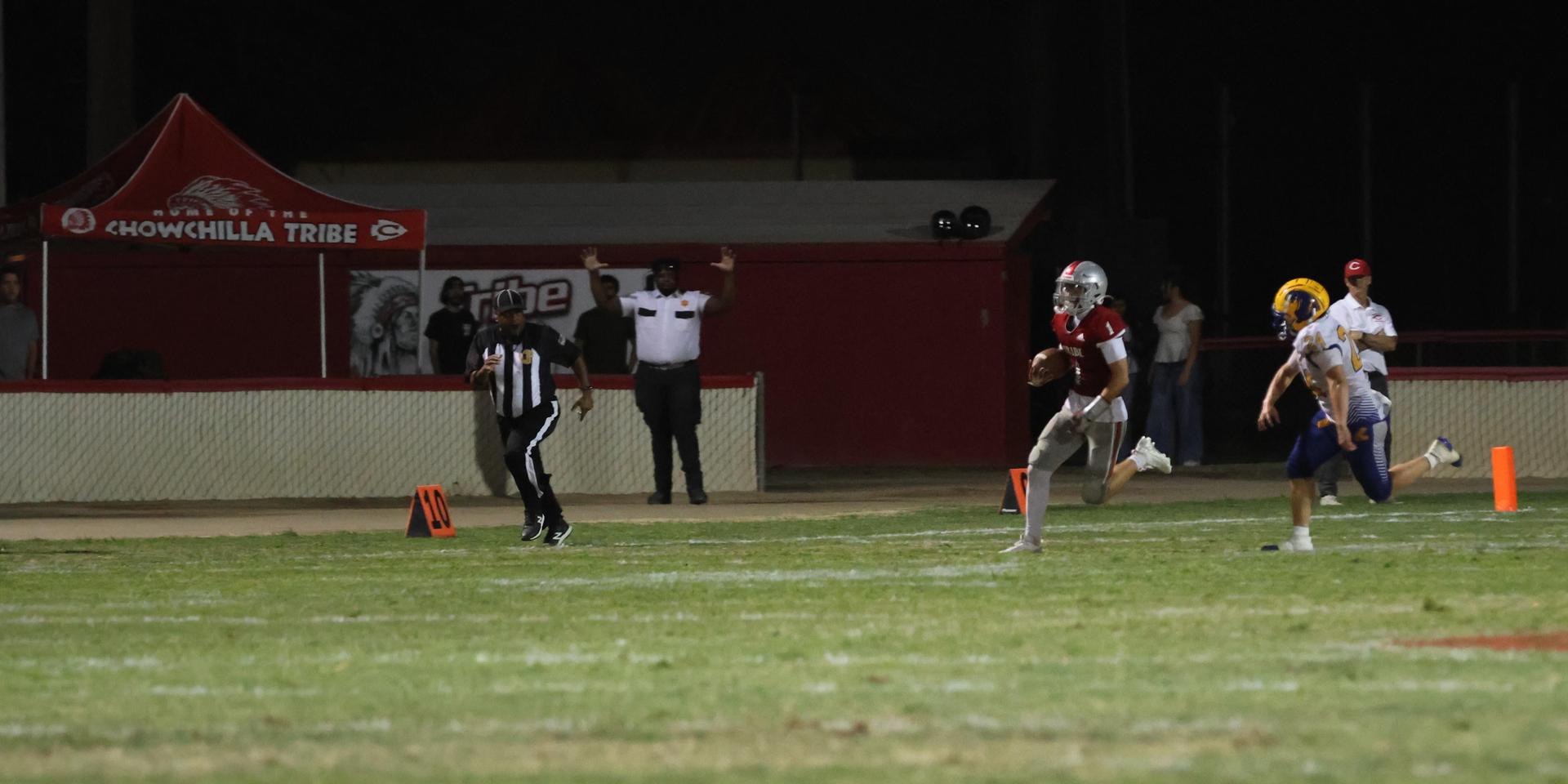 Varsity football players in action against Parlier 43