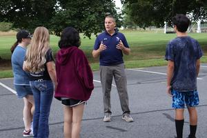 Teacher Shawn Knightly explains emergency protocol outside to freshmen