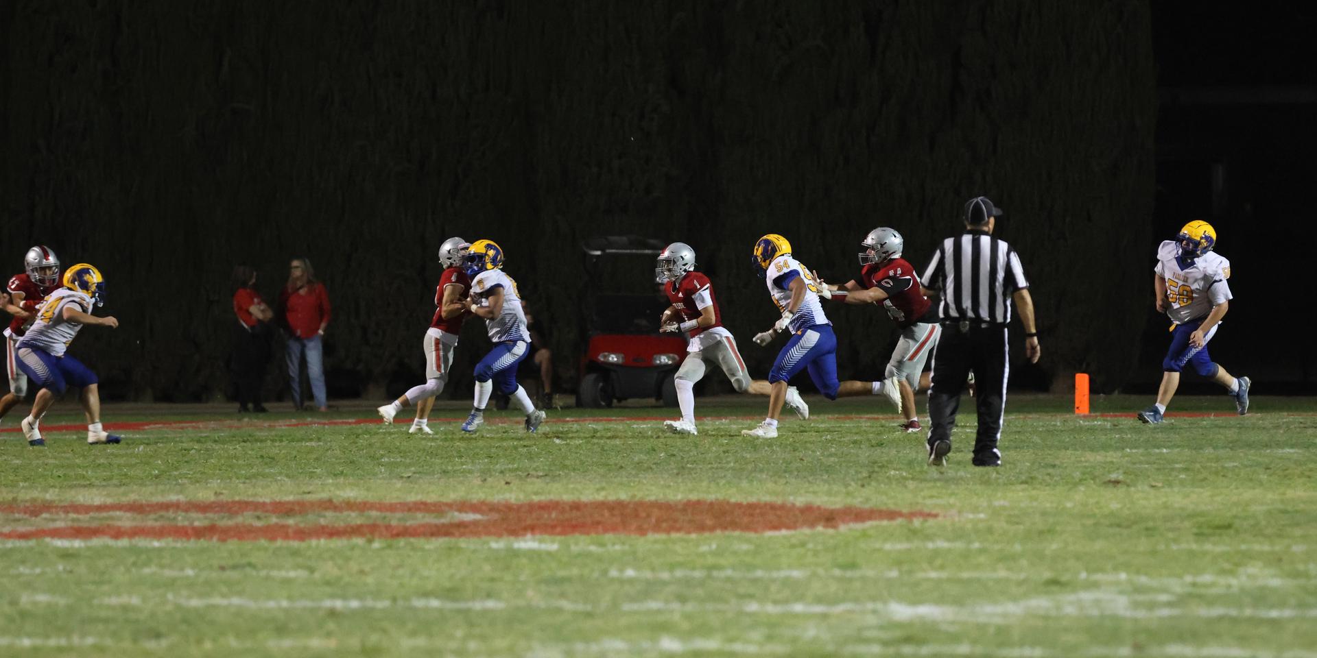 Varsity football players in action against Parlier 40