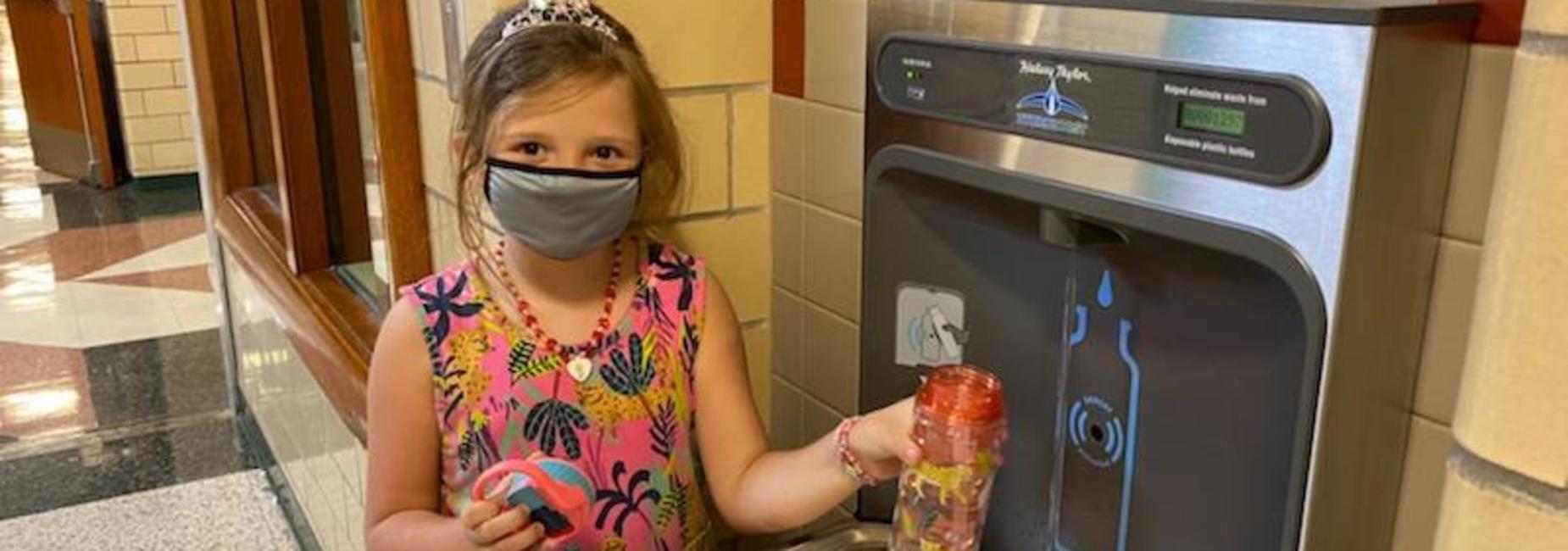 image of student filling water bottle at new water filling station