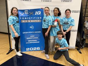 Team Robotic Wolverines poses with banner