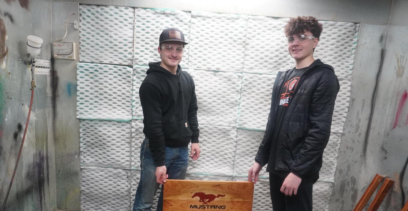 TKHS students show a table top they are making in woods class.