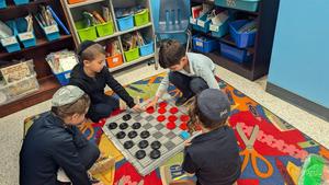 first grade boys playing checkers together