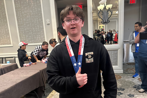 FHS chess club student posing with their state medal