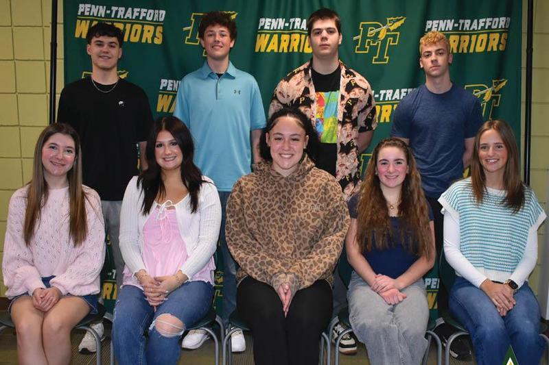 The award winners are gathered in front of a Penn-Trafford backdrop
