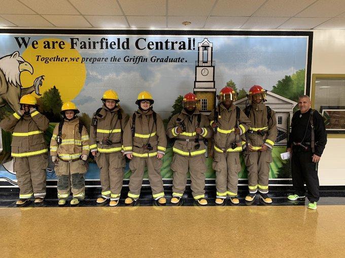 The firefighter students dressed in fire gear.