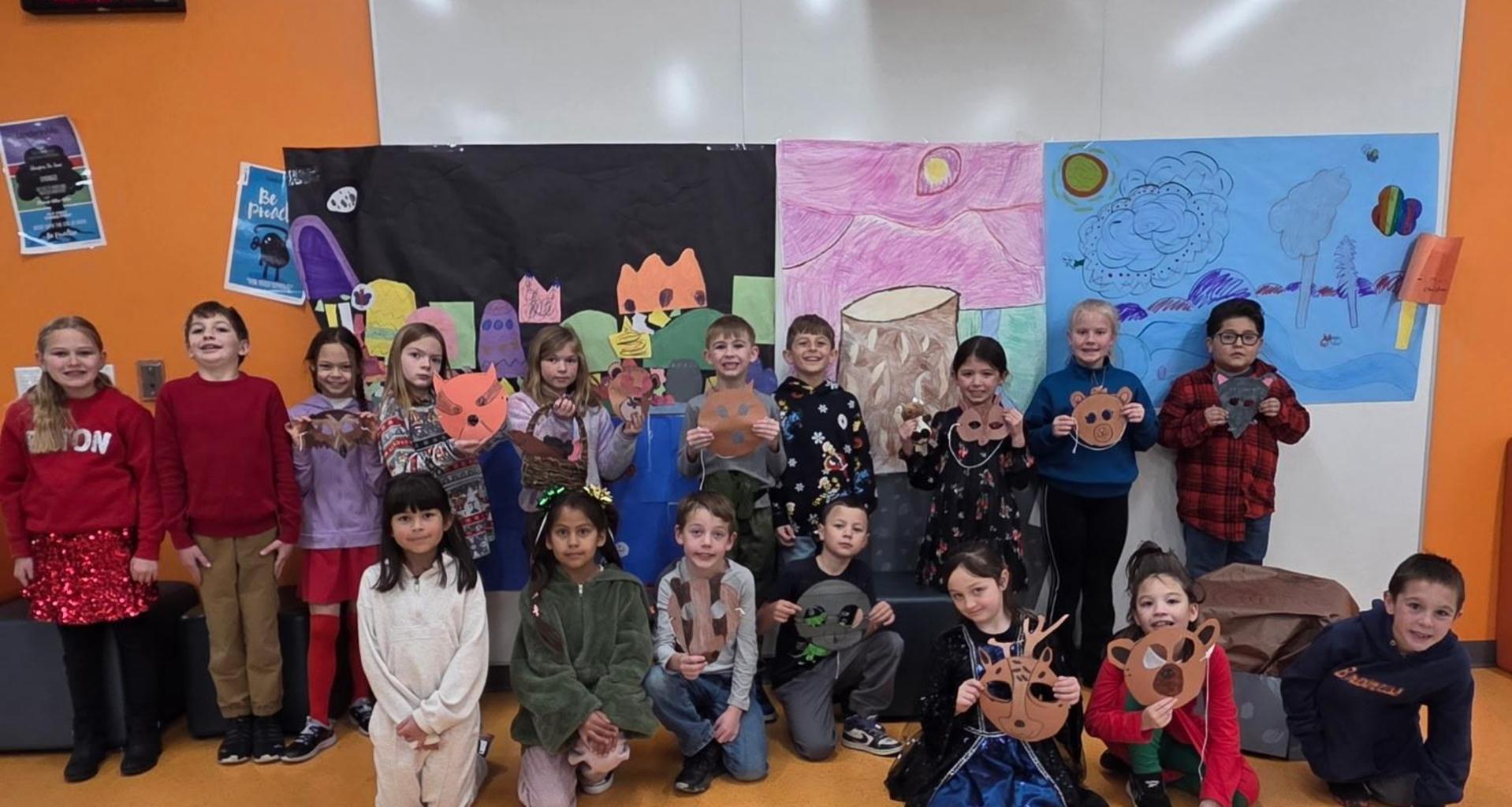 A diverse group of children holding handmade crafts in a colorful classroom setting.