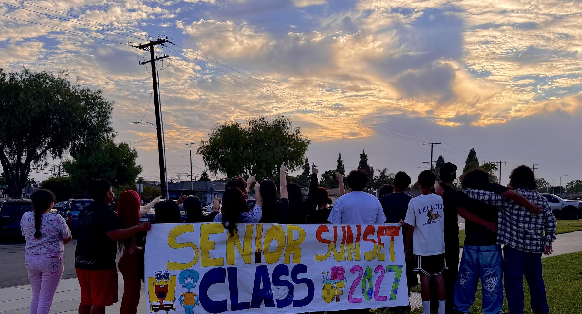 Senior Sunset picture students facing the sun set.