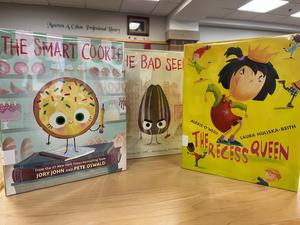 three children's books on display in a school library