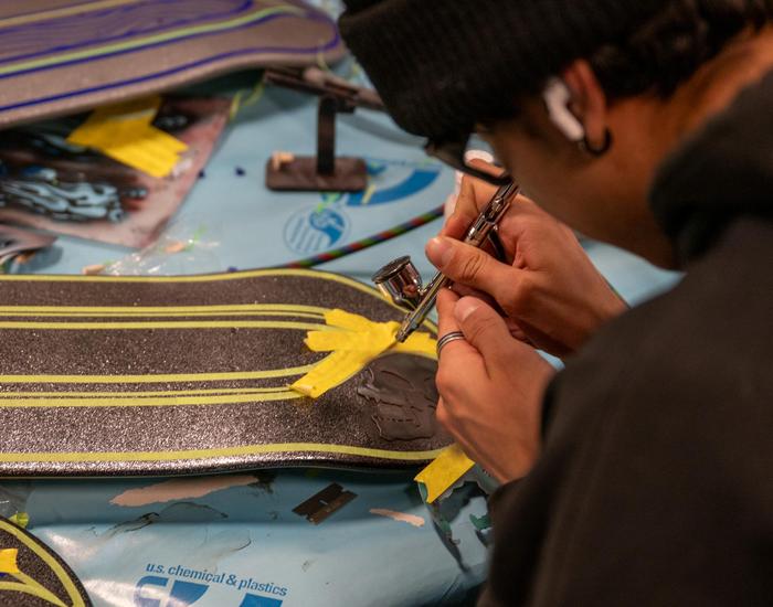 Students design and airbrush skateboards
