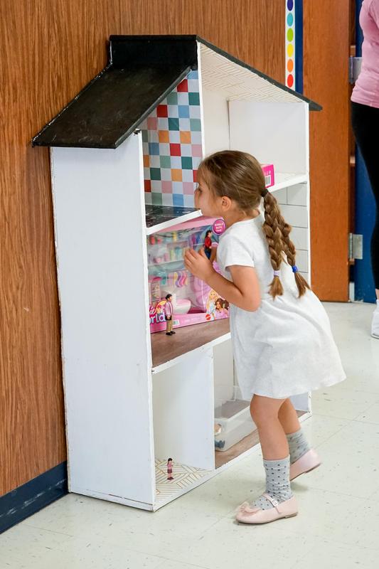 Oak Ridge pre-k student playing with dollhouse