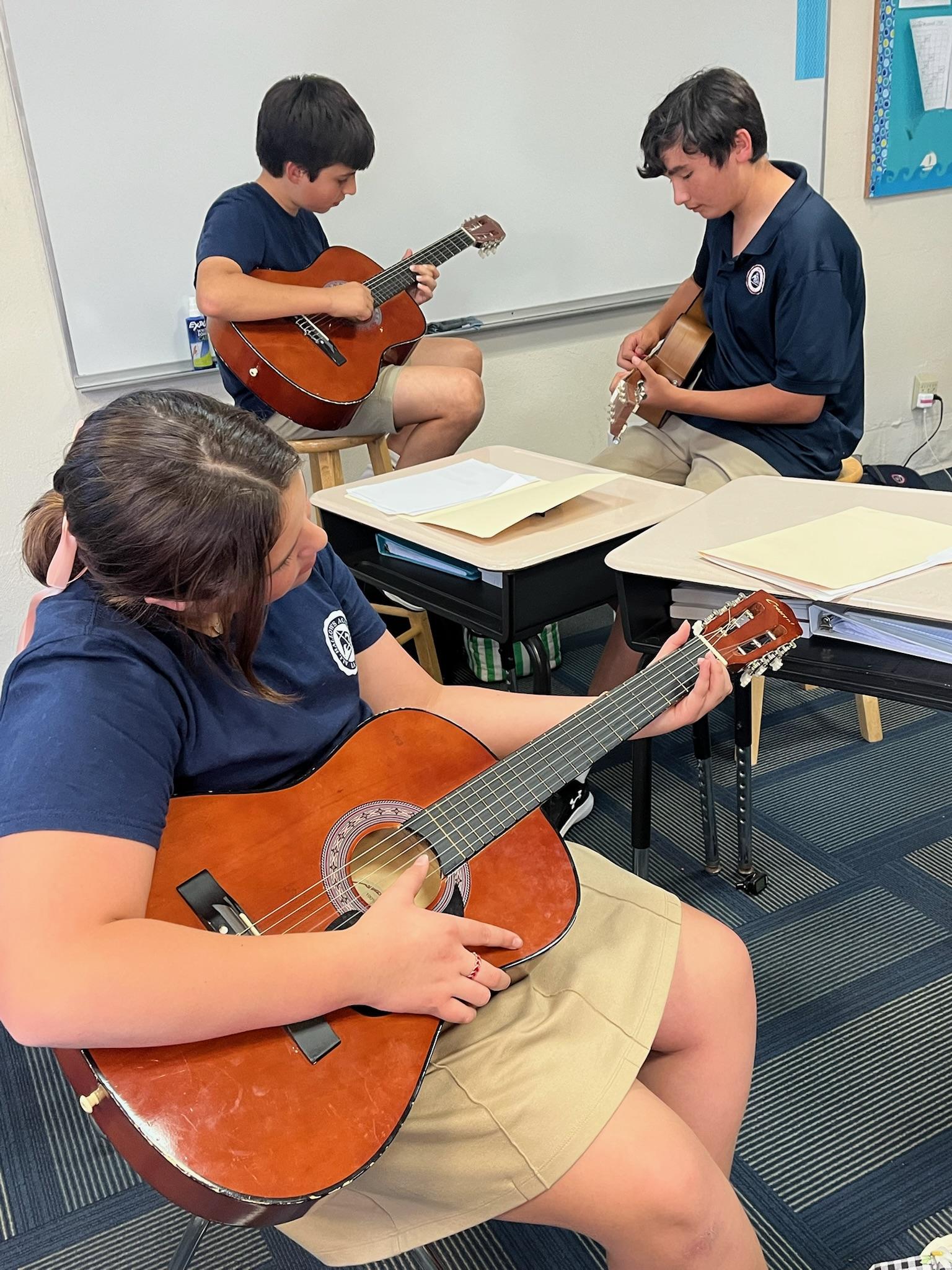 students practicing guitar