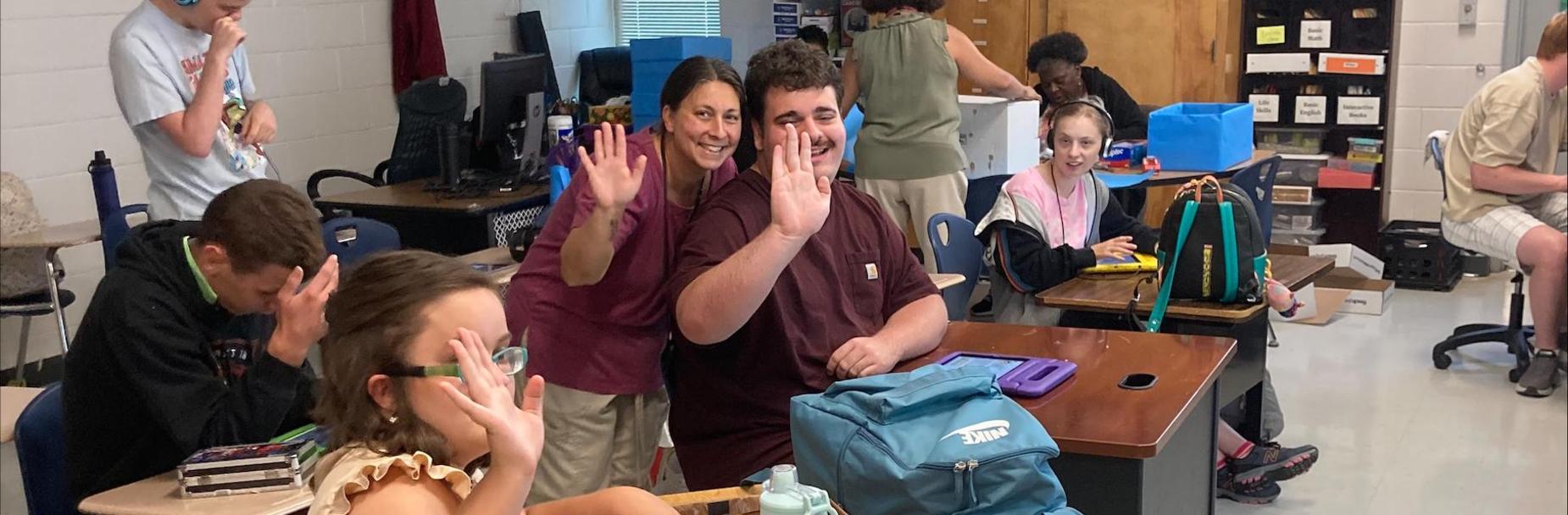 Students waving
