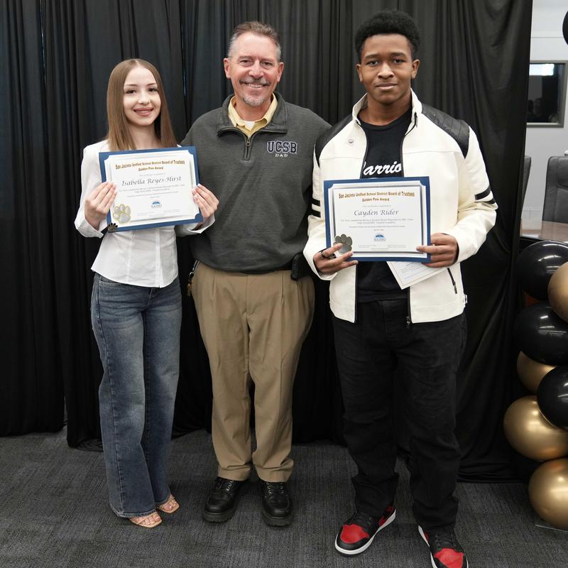 two students and principal at Golden Paw Awards