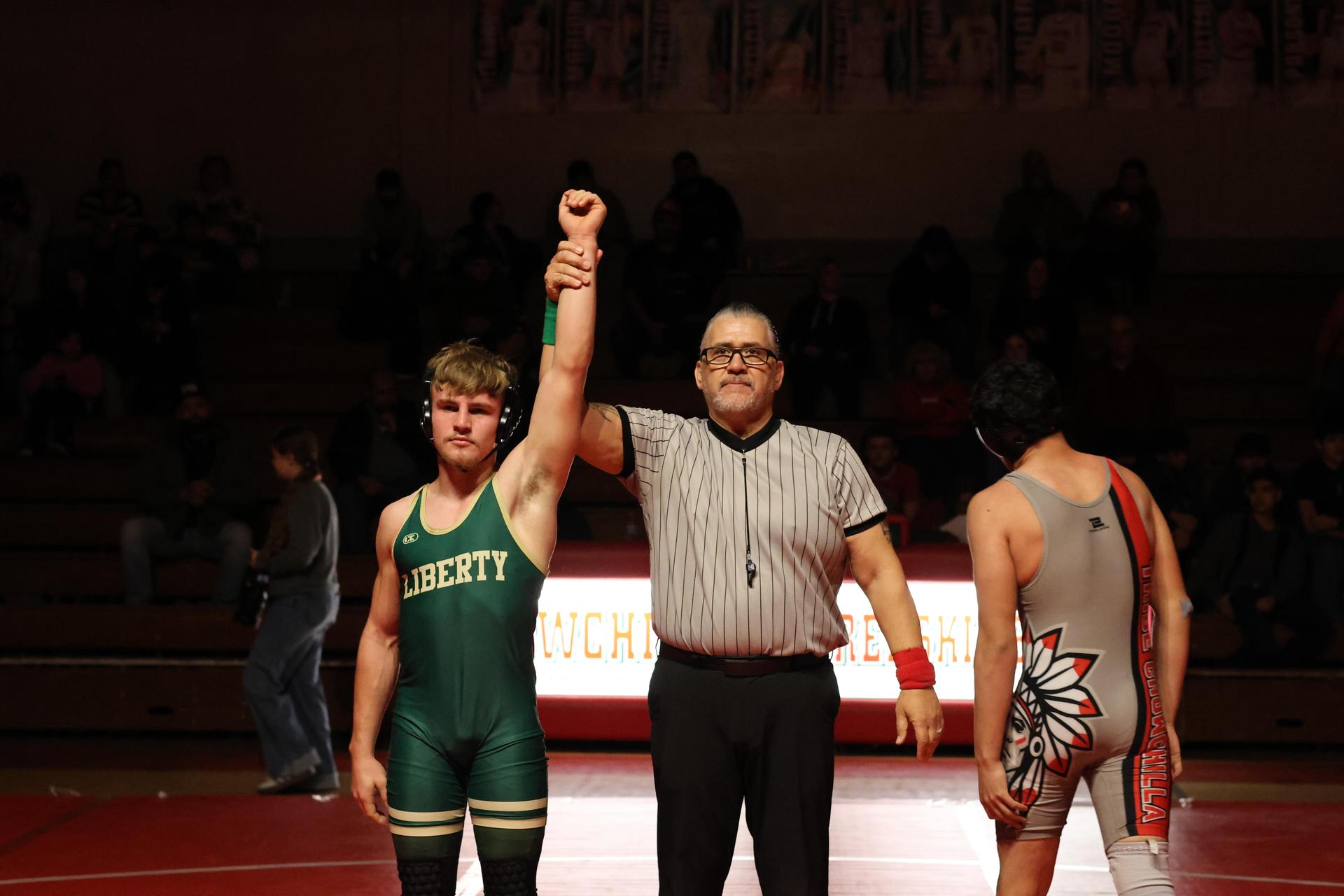 Wrestling winners with hands up 126