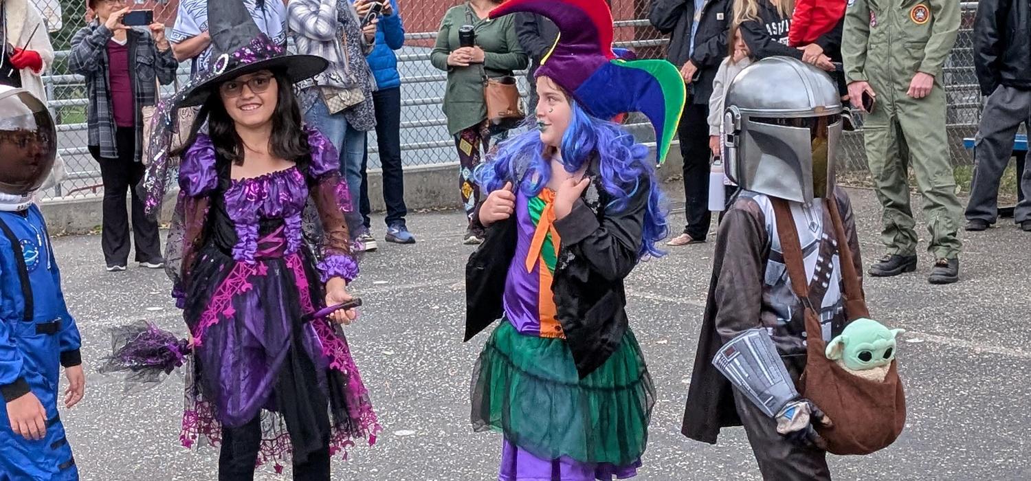 An astronaut, witch, jester, and Mandalorian parade around