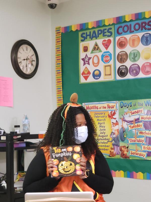 Dr. Buford reads Ten Little Pumpkins to Early Childhood students