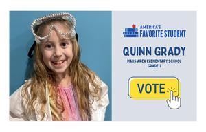 A girl in a lab coat with safety goggles on her head