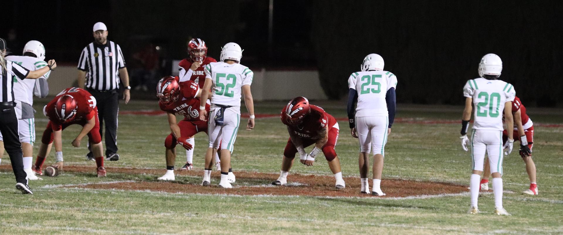 varsity football players in action against Riverdale