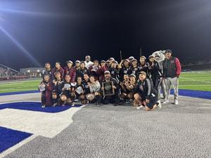 The Granite Hills High School girls soccer team poses on the field at night with their Central Section Division VI championship plaque, celebrating their 1-0 victory over Riverdale. Players and coaches smile, hold up "number one" gestures, and wear medals and team gear, with the school mascot standing proudly in the background.
