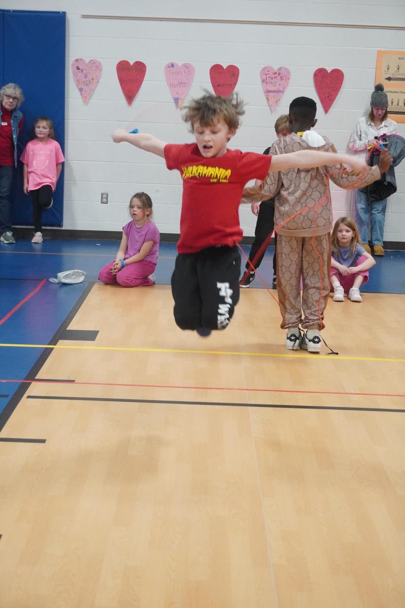 A student jumps high as he clears the rope.
