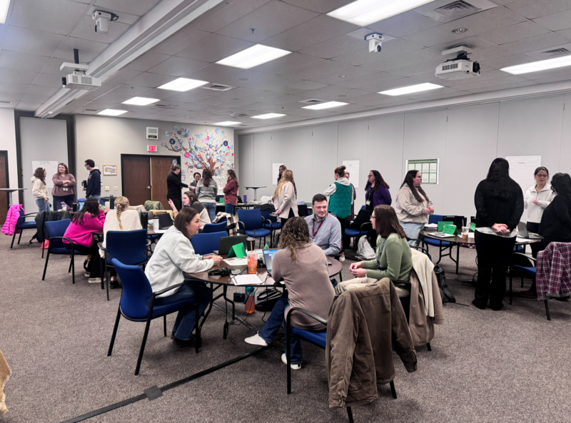 group of educators sitting at tables talking to each other