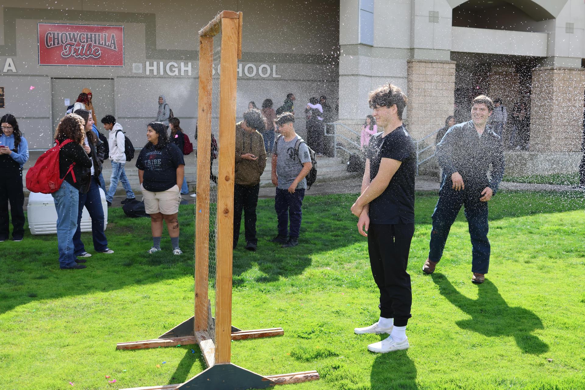 students and staff enjoying the water balloon toss