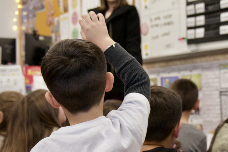 A child holds hand up