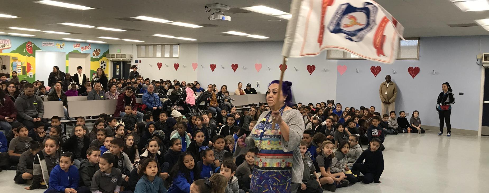 Students recognizing Weekly attendance winners during pep assembly