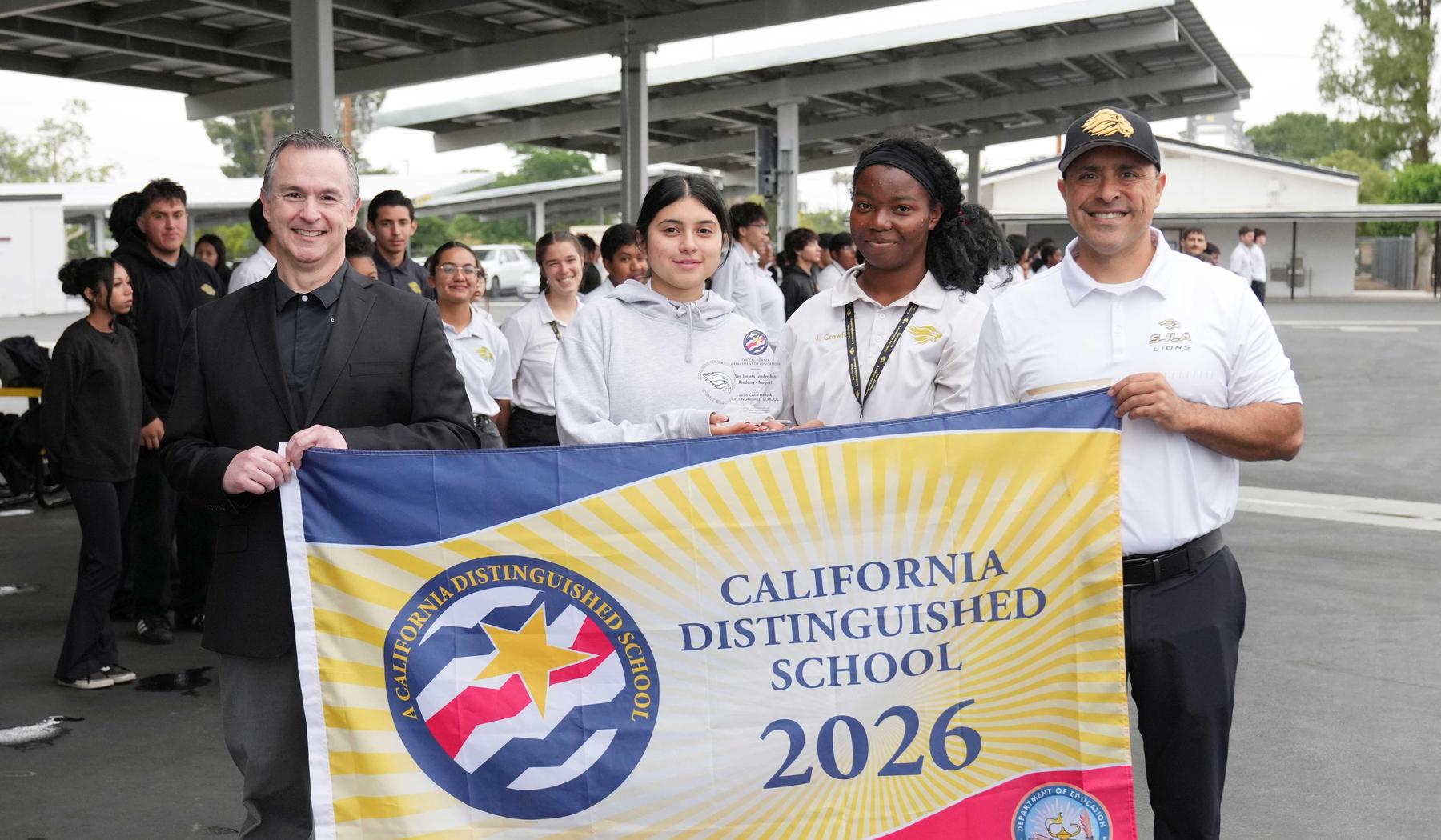 SJLA Distinguished school banner with cadets and staff