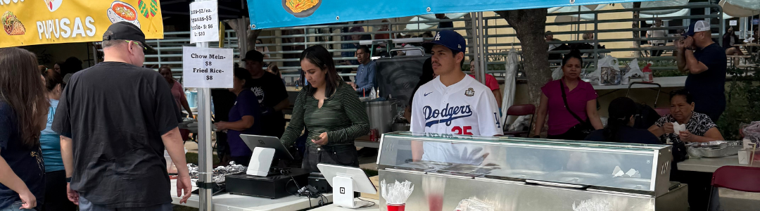 Parents helping to sell food at Family Fun Day