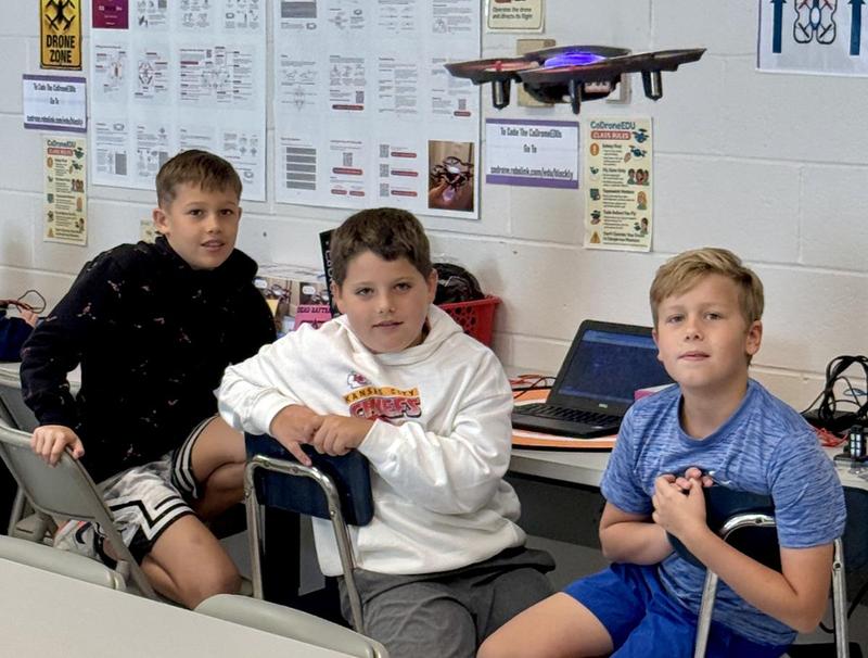 Students working with drones in a STEAM classroom.