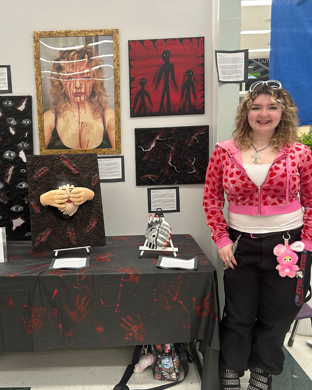 A third student is featured with artwork