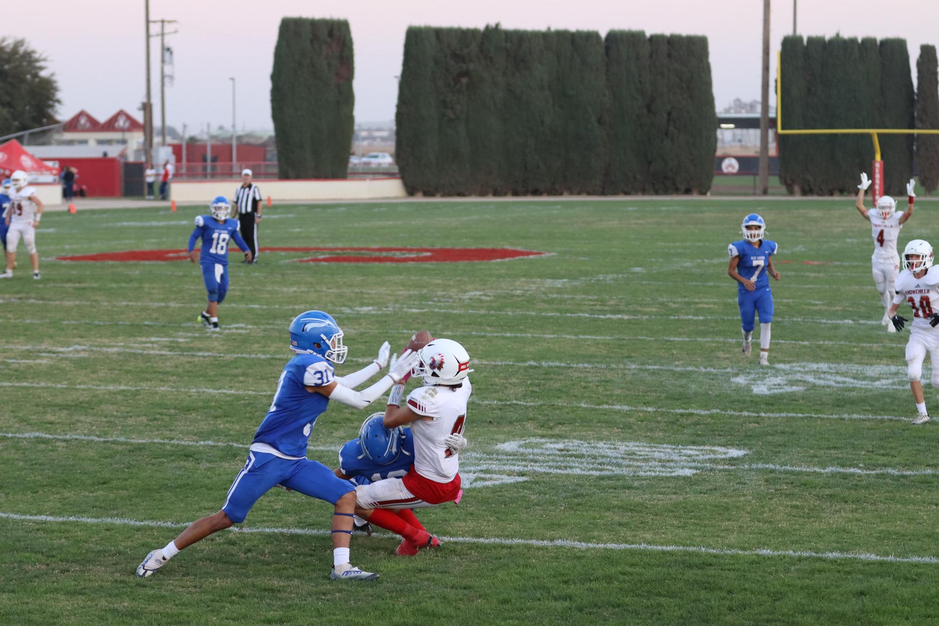 Junior Varsity football players in action against Caruthers