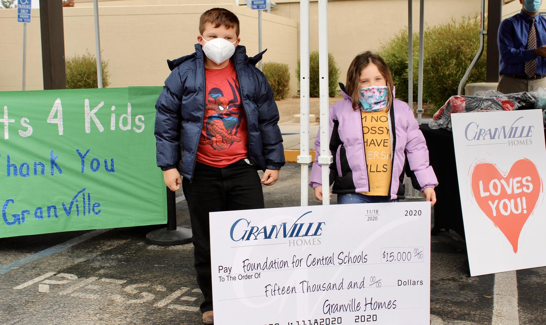 Two Saroyan students proudly displaying their new coats