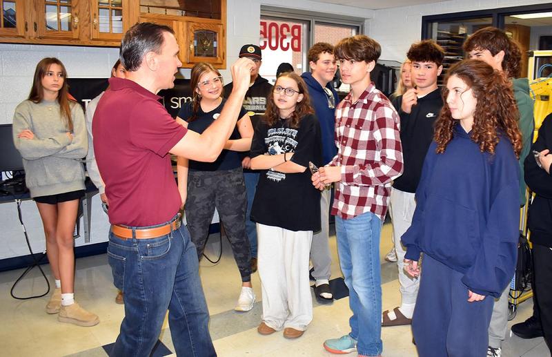 A teacher talks with students