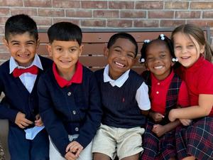Picture of LHS students sitting on a bench.