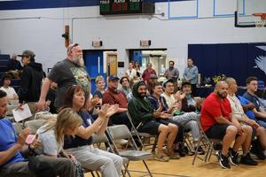 Crowd applauds awarding of certificate